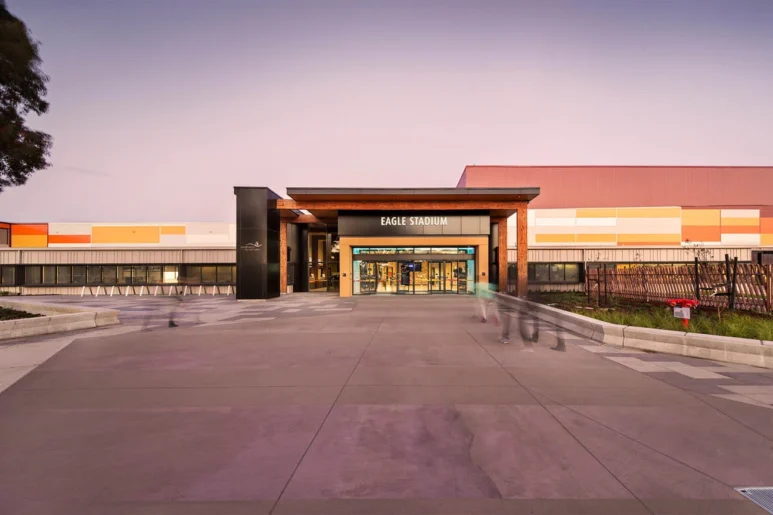 Exterior view of Eagle Stadium in Werribee at dusk, showing the main entrance with modern architecture and signage.