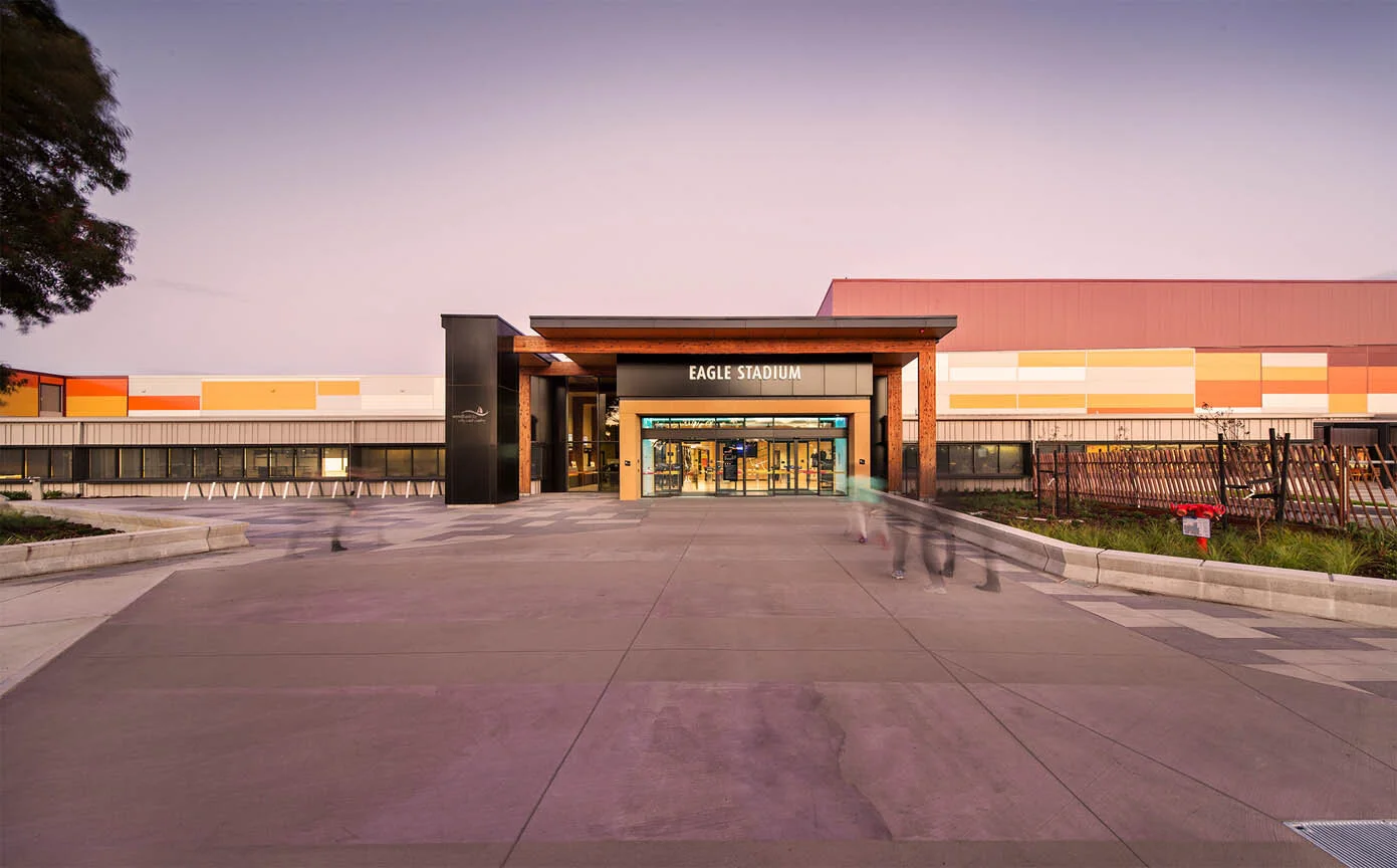 Exterior view of Eagle Stadium in Werribee at dusk, showing the main entrance with modern architecture and signage.