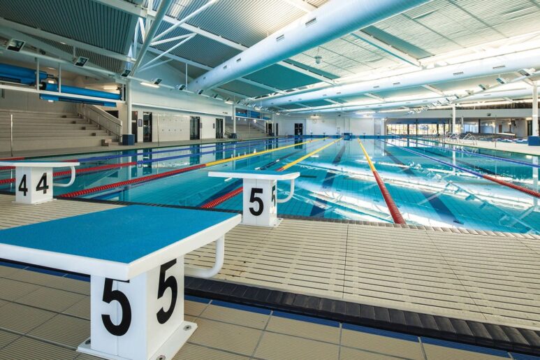 Competition lap pool at AquaPulse Hoppers Crossing with starting blocks, marked lanes, and spectator seating.