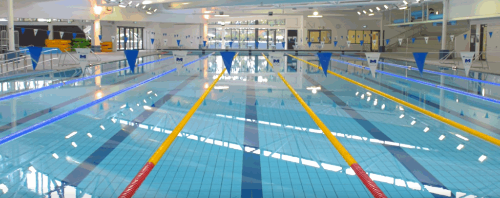 Indoor 50-metre lap pool at AquaPulse Hoppers Crossing with lane dividers and clear water.