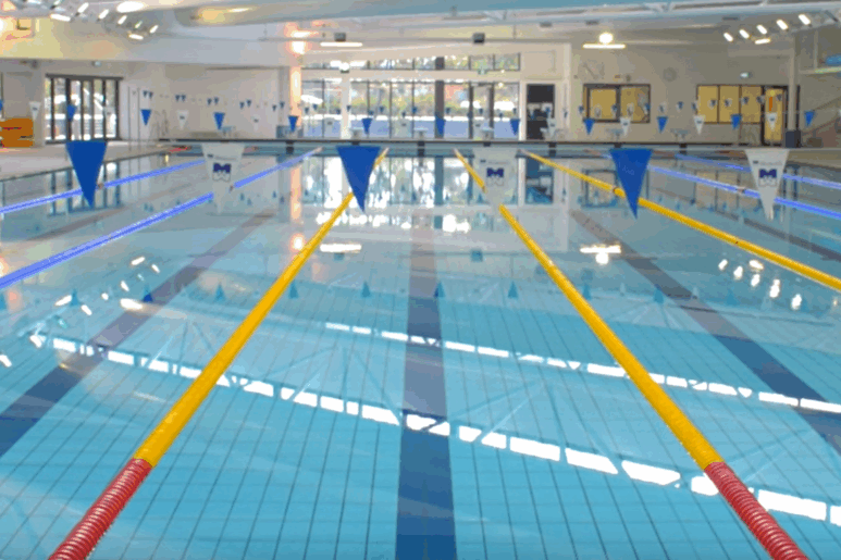Indoor 50-metre lap pool at AquaPulse Hoppers Crossing with lane dividers and clear water.